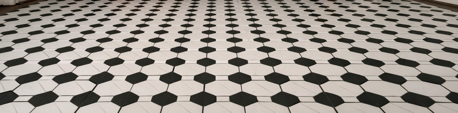Close-up of a black-and-white octagon-and-dot mosaic ceramic tile entryway floor with dark grout, the classic vintage pattern that gives an entryway character and lasts decades